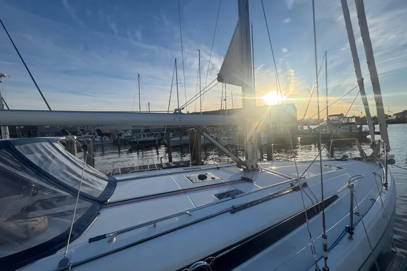 Slide: The Image of 2023 Beneteau Oceanis 40.1 sailboat docked at sunset, marina view. - 3