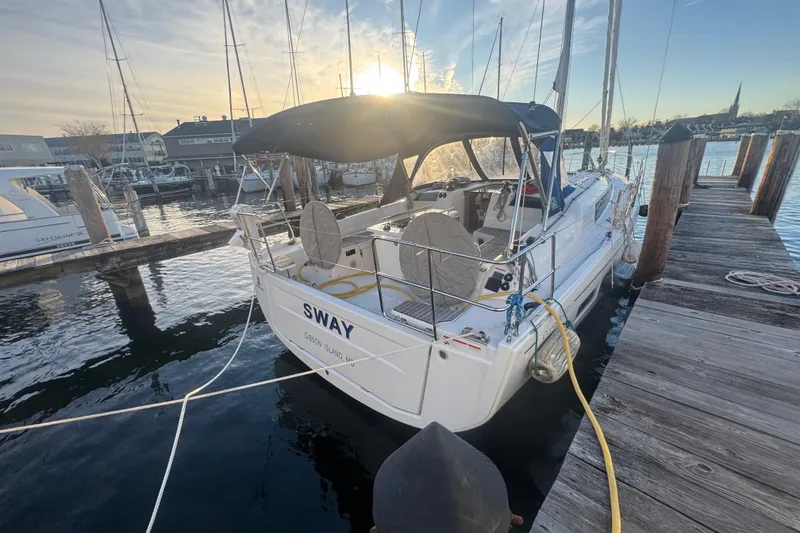 Slide: The Image of 2023 Beneteau Oceanis 40.1 sailboat docked at marina during sunset. - 7