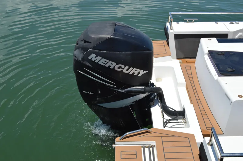 Slide: The Image of 2015 Axopar T-Top boat with Mercury Verado outboard motor on water. - 12