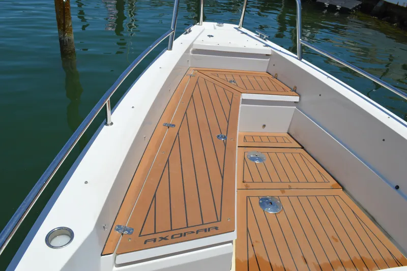Slide: The Image of 2015 Axopar T-Top boat deck with teak flooring, docked on calm water. - 17