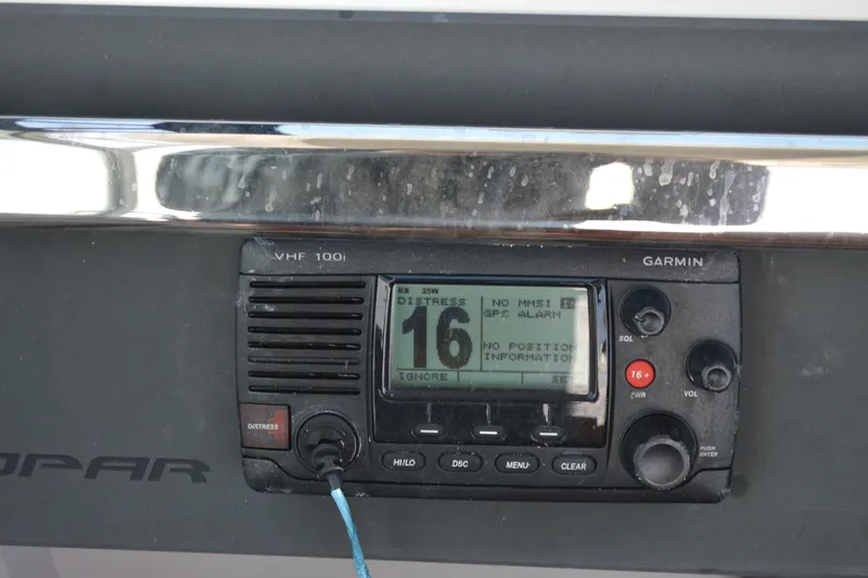 Slide: The Image of Garmin VHF 100i radio on 2015 Axopar T-Top boat dashboard. - 26