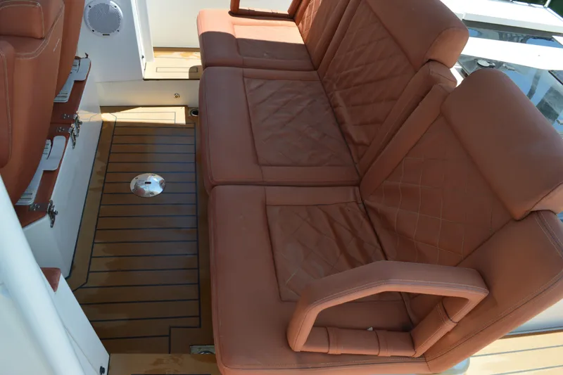 Slide: The Image of 2015 Axopar T-Top boat interior with brown leather seating and teak flooring. - 29
