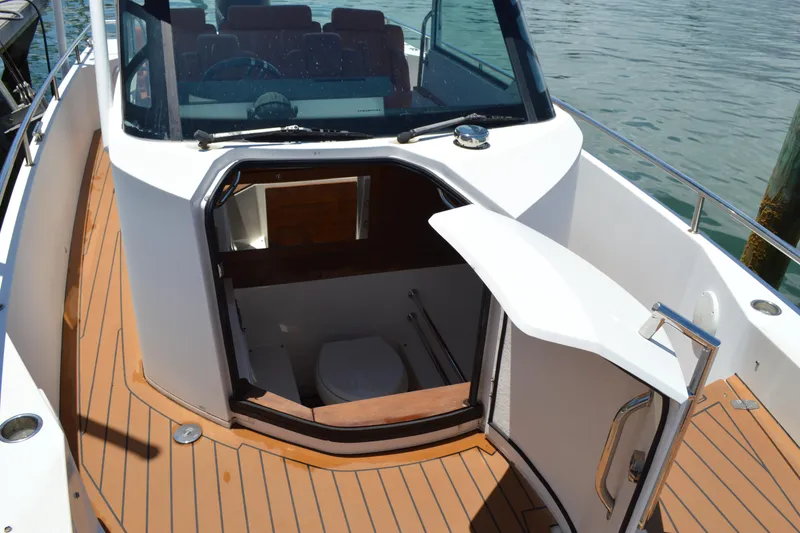 Slide: The Image of 2015 Axopar T-Top boat with open cabin door and teak deck flooring. - 33
