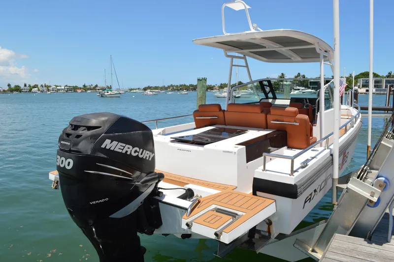Slide: The Image of 2015 Axopar T-Top boat with Mercury engine docked by the water. - 6