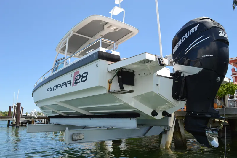 Slide: The Image of 2015 Axopar T-Top boat with Mercury engine, docked on a sunny day. - 7