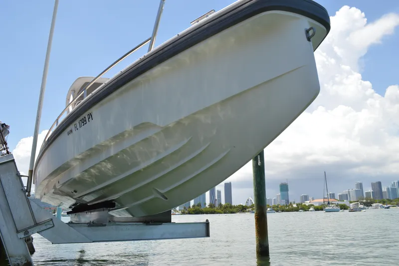 Slide: The Image of 2015 Axopar T-Top boat on lift with city skyline in background. - 9