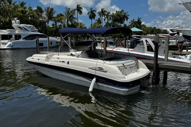 Slide: The Image of 1998 Chaparral Sunesta 232 boat docked in a marina with palm trees. - 1