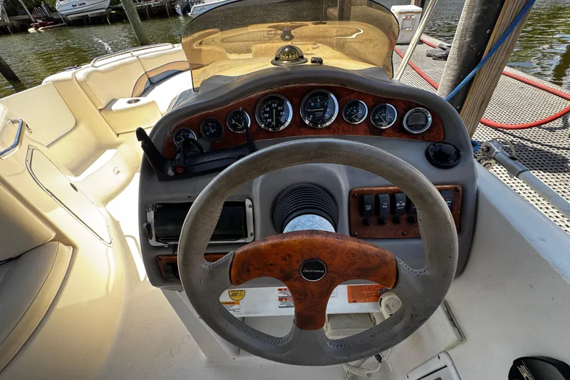 Slide: The Image of 2000 Chaparral Sunesta 232 boat dashboard with steering wheel and instrument panel. - 11