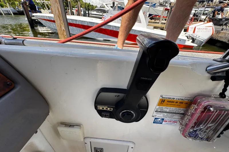 Slide: The Image of Control panel of a 2000 Chaparral Sunesta 232 boat, docked near other vessels. - 13