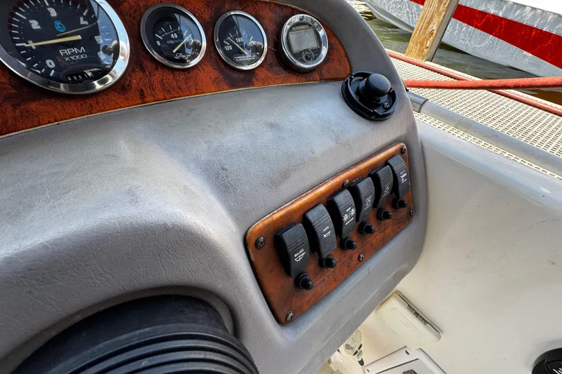 Slide: The Image of Dashboard of 2000 Chaparral Sunesta 232 boat with gauges and switches. - 14