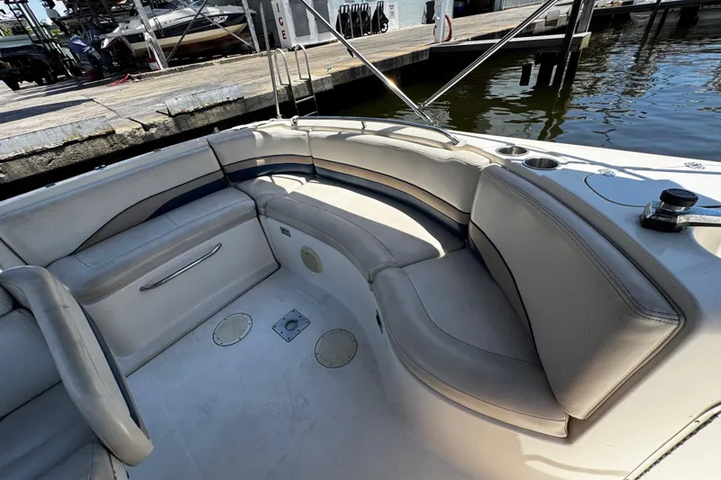 Slide: The Image of 2000 Chaparral Sunesta 232 boat interior with cushioned seating at dock. - 17