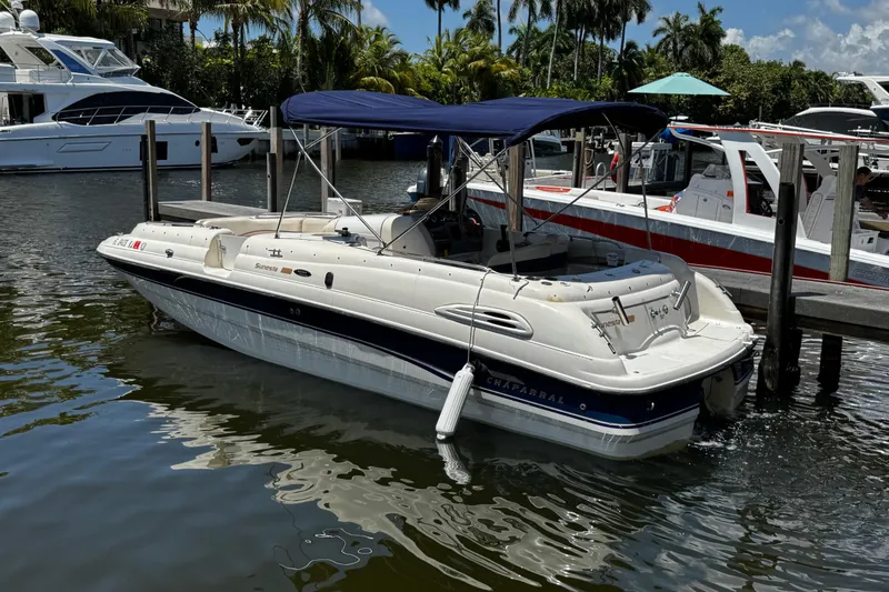 Slide: The Image of 2000 Chaparral Sunesta 232 boat docked in a marina with blue canopy. - 2