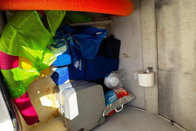 Slide: The Image of Storage compartment in a 2000 Chaparral Sunesta 232 boat with life vests and supplies. - 20