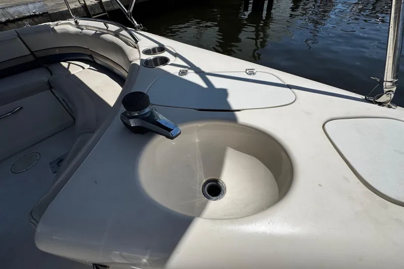 Slide: The Image of 2000 Chaparral Sunesta 232 boat interior with sink and seating area. - 21