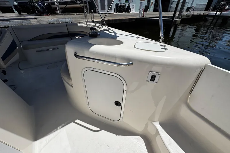 Slide: The Image of 2000 Chaparral Sunesta 232 boat interior with seating and storage compartment. - 22