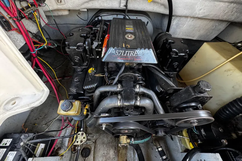 Slide: The Image of Engine compartment of a 2000 Chaparral Sunesta 232 boat, featuring a 5.7L engine. - 24