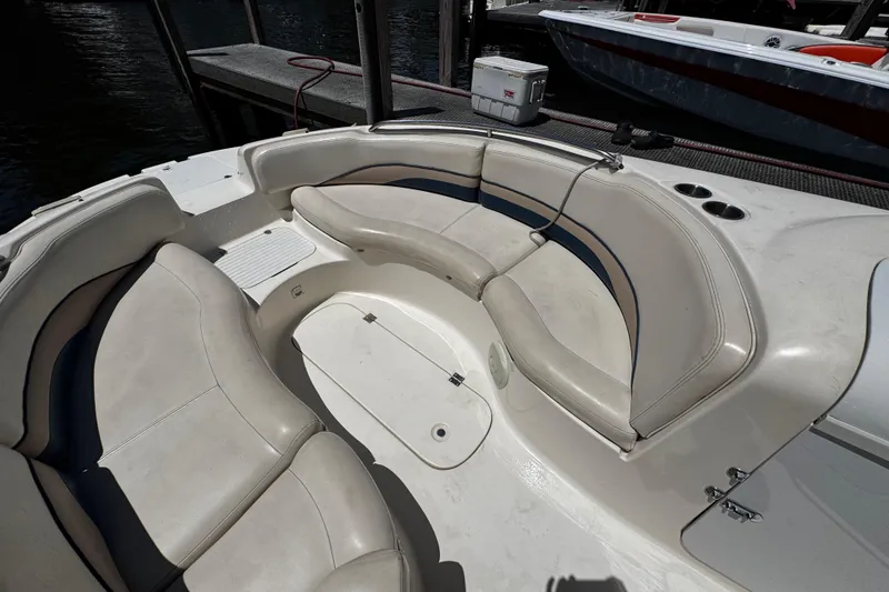 Slide: The Image of 2000 Chaparral Sunesta 232 boat interior with curved seating and cup holders. - 27