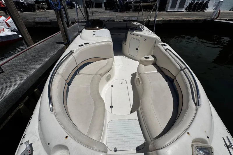 Slide: The Image of 2000 Chaparral Sunesta 232 boat interior with spacious seating at dock. - 29