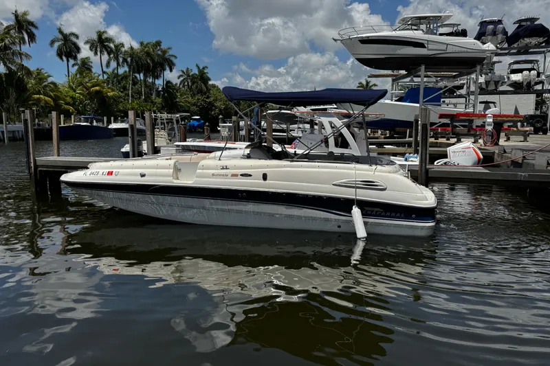 Slide: The Image of 2000 Chaparral Sunesta 232 boat docked at marina under blue sky. - 3