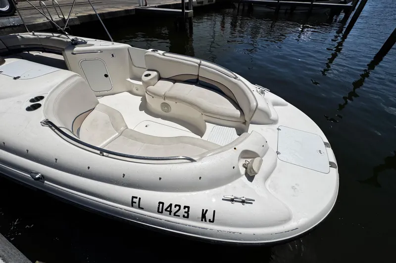 Slide: The Image of 2000 Chaparral Sunesta 232 boat docked, featuring spacious seating and sleek design. - 31