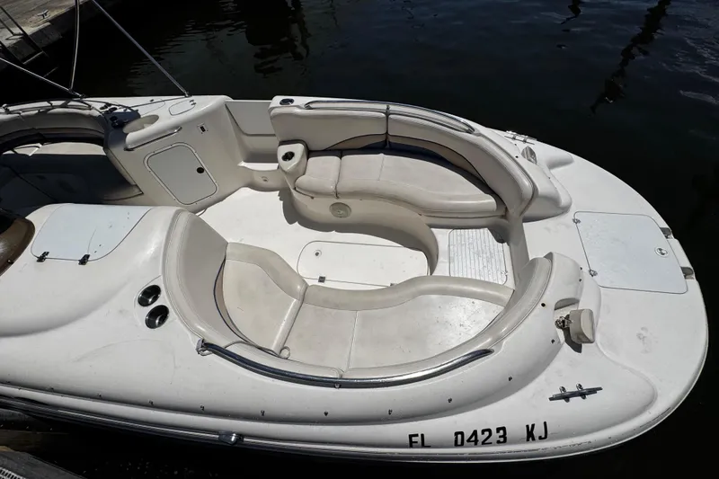 Slide: The Image of 2000 Chaparral Sunesta 232 boat interior with white seating and storage compartments. - 32