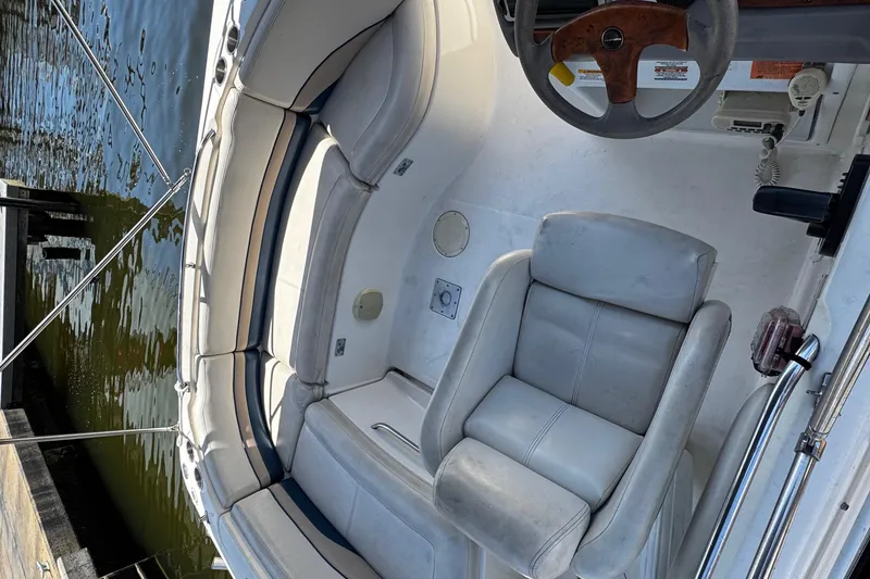 Slide: The Image of 2000 Chaparral Sunesta 232 boat interior with seating and steering wheel. - 33