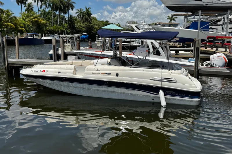 Slide: The Image of 2000 Chaparral Sunesta 232 boat docked in a marina with palm trees. - 4