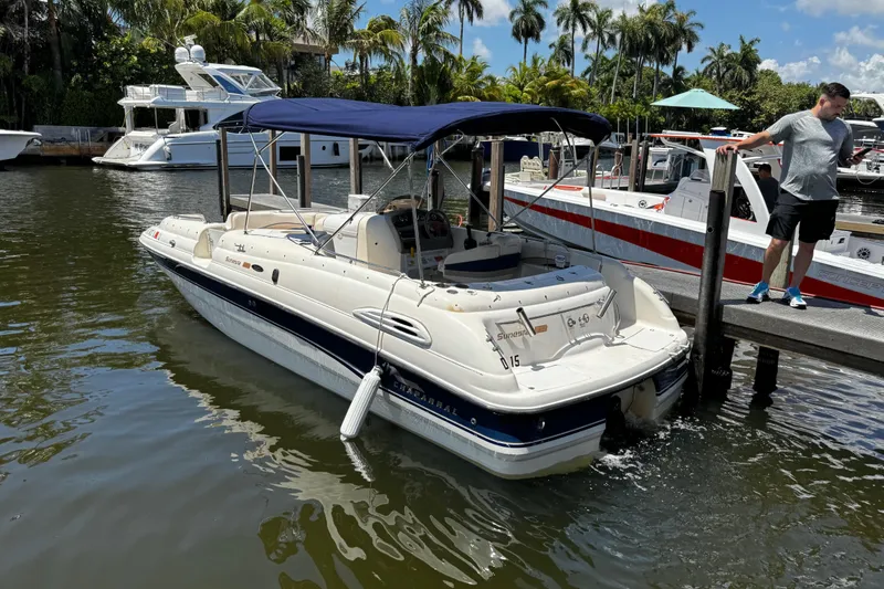 Slide: The Image of 2000 Chaparral Sunesta 232 boat docked in a sunny marina with palm trees. - 5