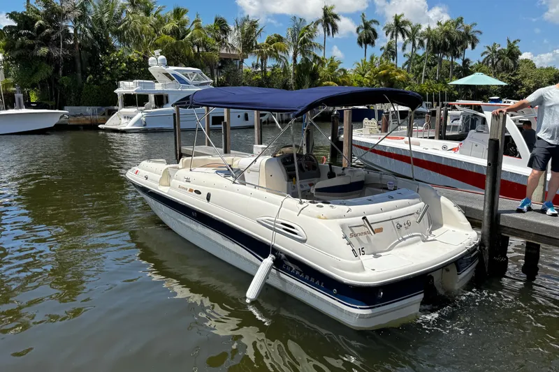 Slide: The Image of 2000 Chaparral Sunesta 232 boat docked in a scenic marina with lush greenery. - 6