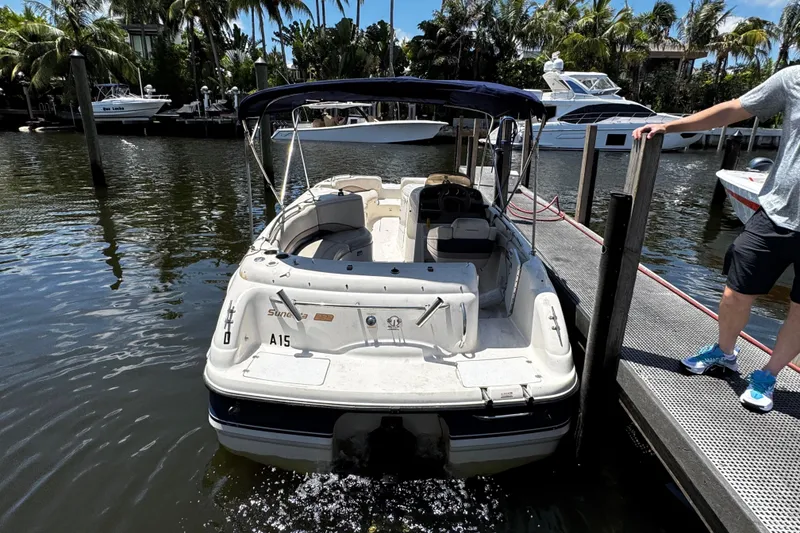 Slide: The Image of 2000 Chaparral Sunesta 232 boat docked in a scenic marina setting. - 7