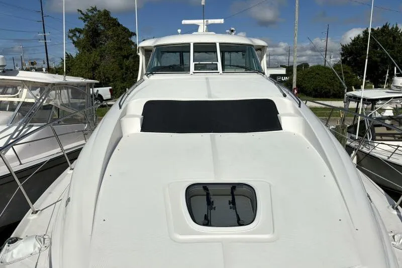 Slide: The Image of 2006 Sea Ray 40 Motor Yacht, white exterior, docked with clear sky background. - 10