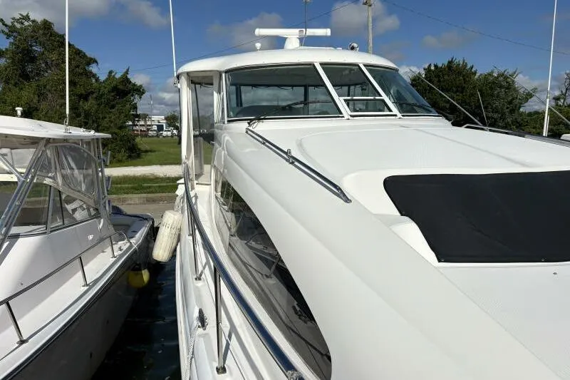 Slide: The Image of 2006 Sea Ray 40 Motor Yacht docked, showcasing sleek design and white exterior. - 11