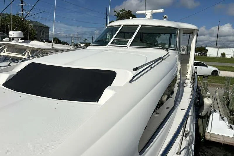 Slide: The Image of 2006 Sea Ray 40 Motor Yacht docked, showcasing sleek design and spacious deck. - 12
