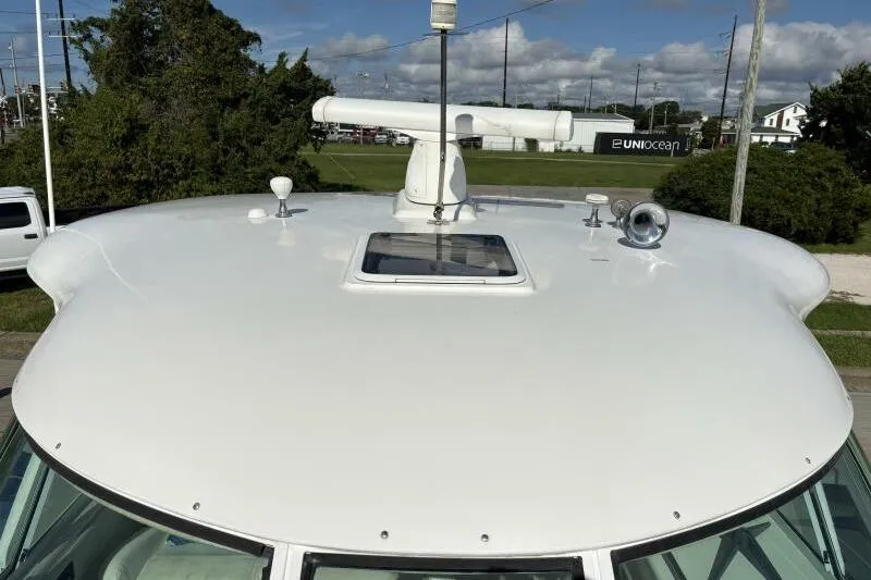 Slide: The Image of 2006 Sea Ray 40 Motor Yacht rooftop with radar and hatch, parked outdoors. - 13