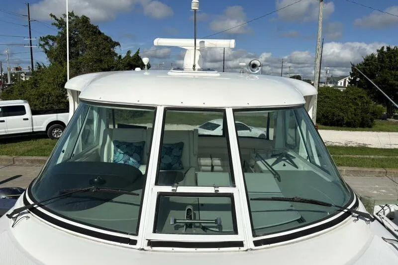 Slide: The Image of 2006 Sea Ray 40 Motor Yacht with sleek windshield and radar, docked under blue skies. - 14