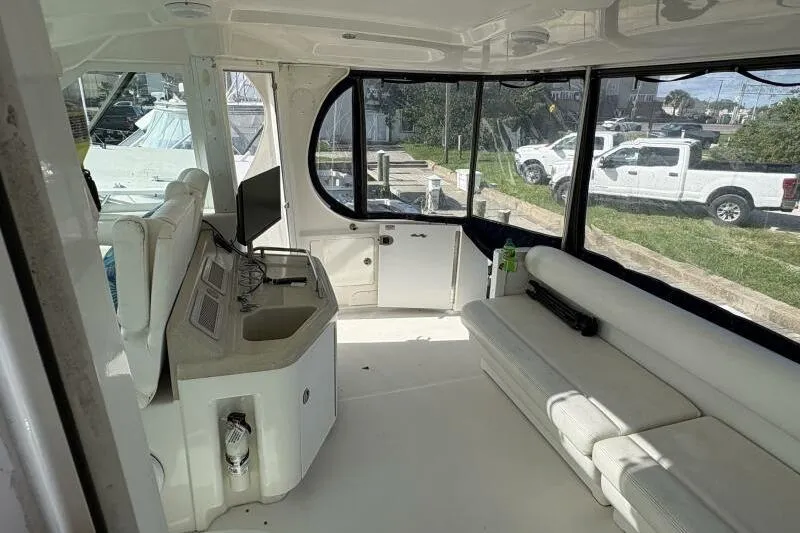 Slide: The Image of Interior of 2006 Sea Ray 40 Motor Yacht with white seating and control panel. - 16
