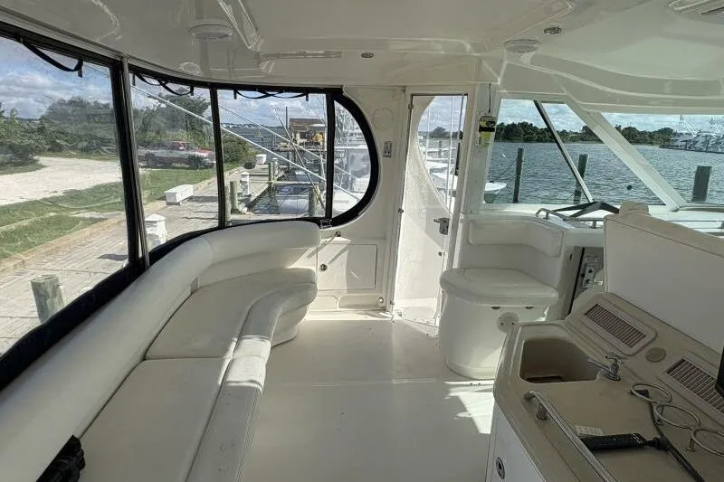 Slide: The Image of Interior of 2006 Sea Ray 40 Motor Yacht with white seating and helm station. - 17