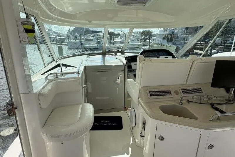 Slide: The Image of 2006 Sea Ray 40 Motor Yacht interior with helm, seating, and sink. - 19