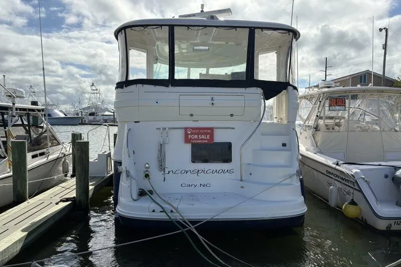 Slide: The Image of 2006 Sea Ray 40 Motor Yacht docked, for sale sign visible, cloudy sky background. - 2