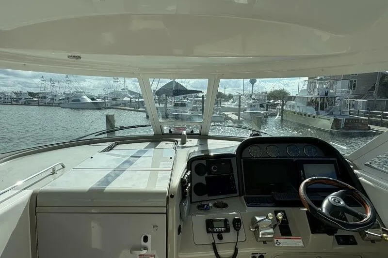 Slide: The Image of 2006 Sea Ray 40 Motor Yacht helm view, marina background, sunny day. - 20