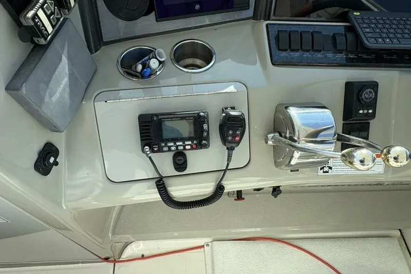 Slide: The Image of Control panel of a 2006 Sea Ray 40 Motor Yacht with radio and throttle. - 22