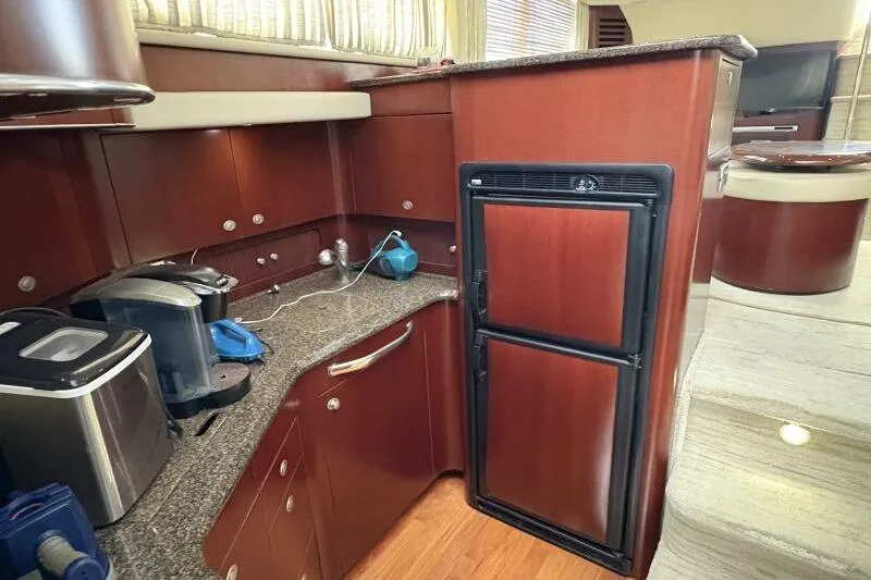 Slide: The Image of 2006 Sea Ray 40 Motor Yacht kitchen with wood cabinetry and modern appliances. - 28