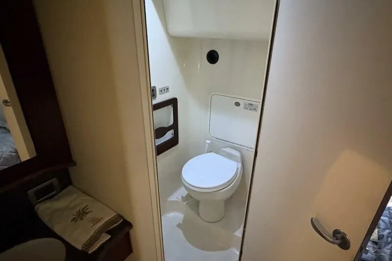 Slide: The Image of Bathroom interior of 2006 Sea Ray 40 Motor Yacht, featuring a compact toilet setup. - 39