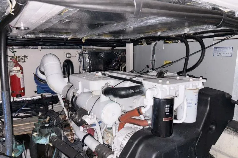 Slide: The Image of Engine room of a 2006 Sea Ray 40 Motor Yacht with visible machinery and fire extinguisher. - 42