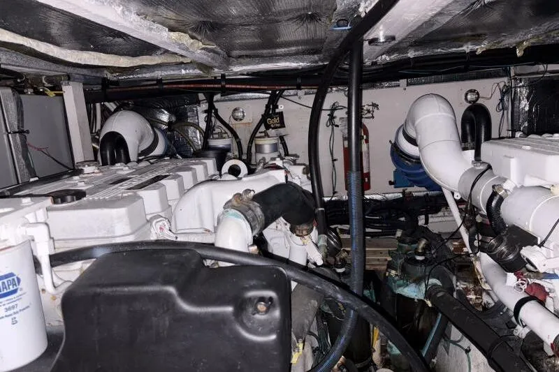 Slide: The Image of Engine room of a 2006 Sea Ray 40 Motor Yacht, showcasing mechanical components and piping. - 43