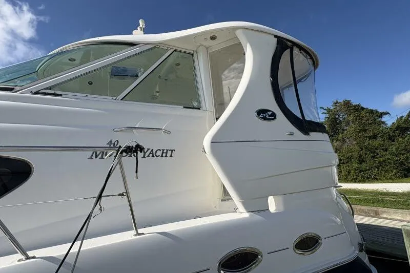 Slide: The Image of 2006 Sea Ray 40 Motor Yacht, white exterior, docked under clear blue sky. - 8
