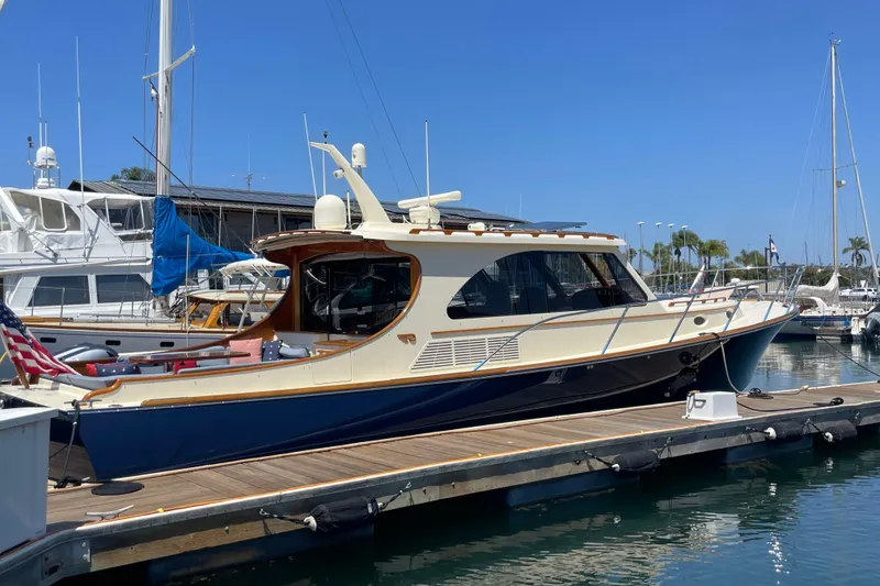 Slide: The Image of 2017 Hinckley Talaria 43 Motoryacht docked at marina under clear blue sky. - 0