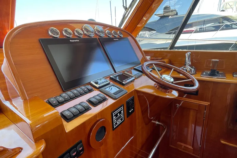 Slide: The Image of 2017 Hinckley Talaria 43 Motoryacht helm with dual screens and wooden steering wheel. - 14