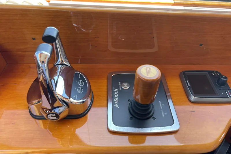 Slide: The Image of Hinckley Talaria 43 Motoryacht 2017 helm controls with joystick and throttle levers. - 16