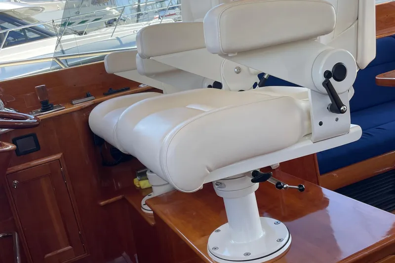 Slide: The Image of Luxurious helm seat on 2017 Hinckley Talaria 43 Motoryacht, featuring elegant white upholstery. - 19